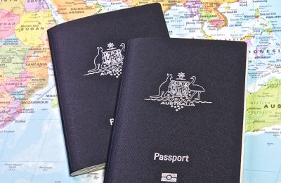 Australian passport with the world map in the background
